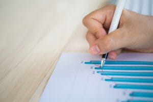Hand write on various financial charts on the table